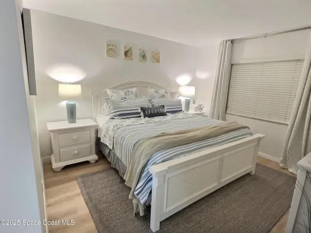 a spacious bedroom with a bed and a couch