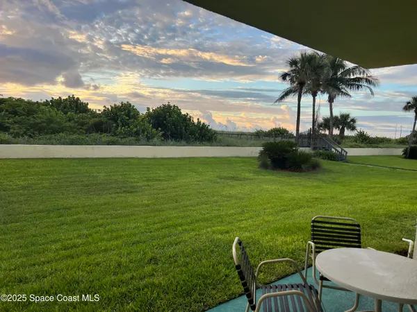 a view of a table and chairs in the garden