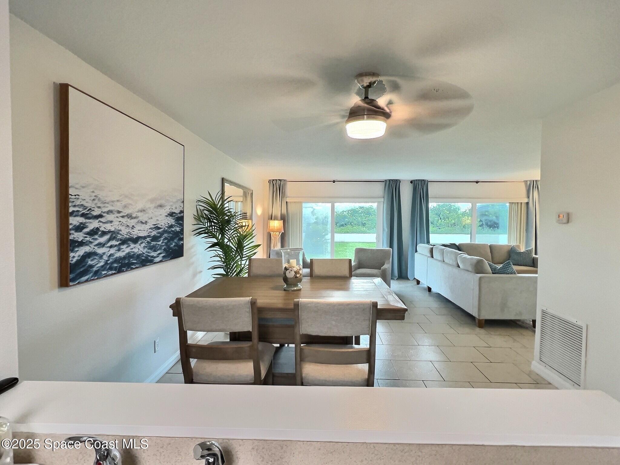 4570 Ocean Beach Boulevard, Unit 104 Cocoa Beach, FL 32931 - Photo 8 of 18 a living room with furniture and a large window