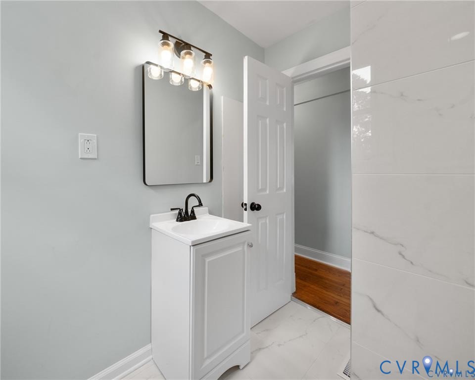 2105 Clarke Street Henrico, VA 23228 - Photo 11 of 26 a bathroom with a sink and a mirror