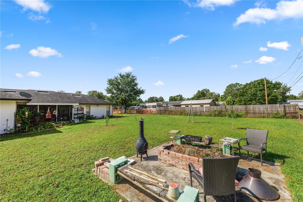 3075 Flamingo Lane Mulberry, FL 33860 - Photo 22 of 30 a view of a patio with furniture and garden
