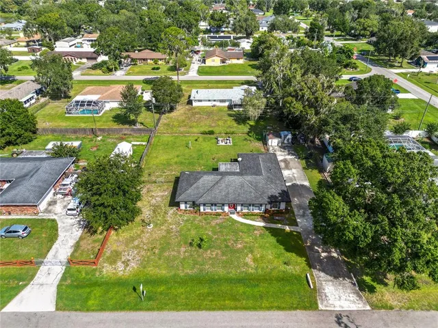 an aerial view of a residential houses with outdoor space