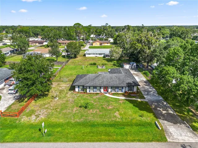 an aerial view of a house with a yard