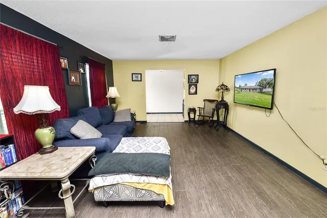 a living room with furniture and wooden floor