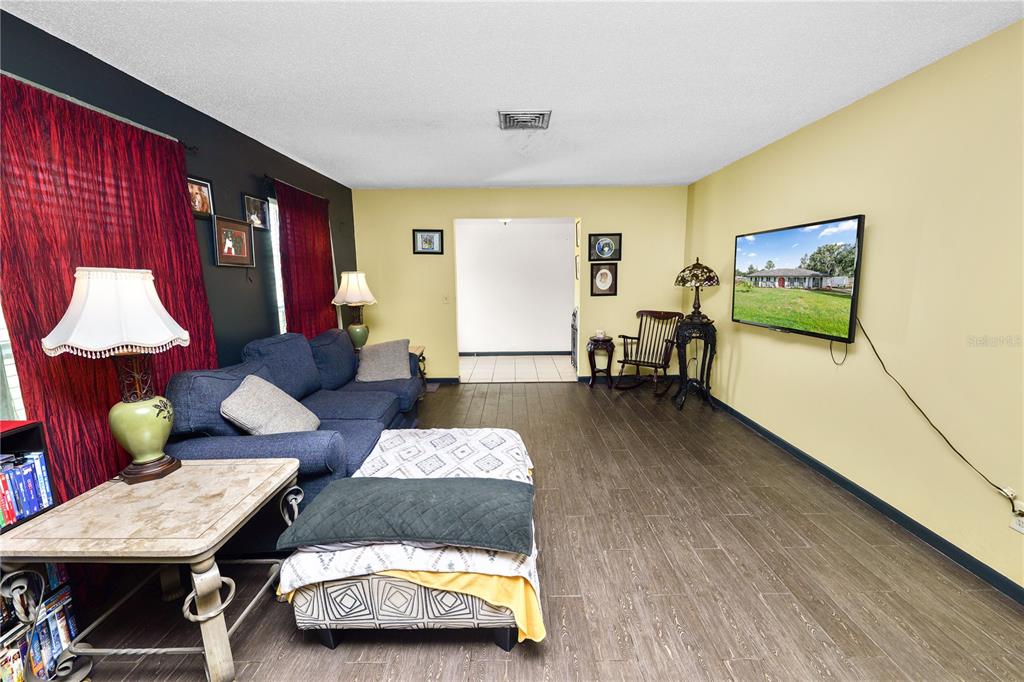 3075 Flamingo Lane Mulberry, FL 33860 - Photo 5 of 30 a living room with furniture and wooden floor