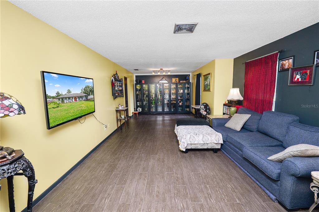 3075 Flamingo Lane Mulberry, FL 33860 - Photo 7 of 30 a living room with furniture and a flat screen tv