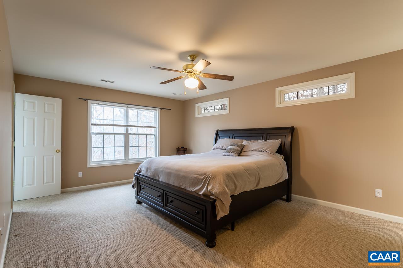 30 Amethyst Road Palmyra, VA 22963 - Photo 17 of 37 a spacious bedroom with a bed and a ceiling fan in it