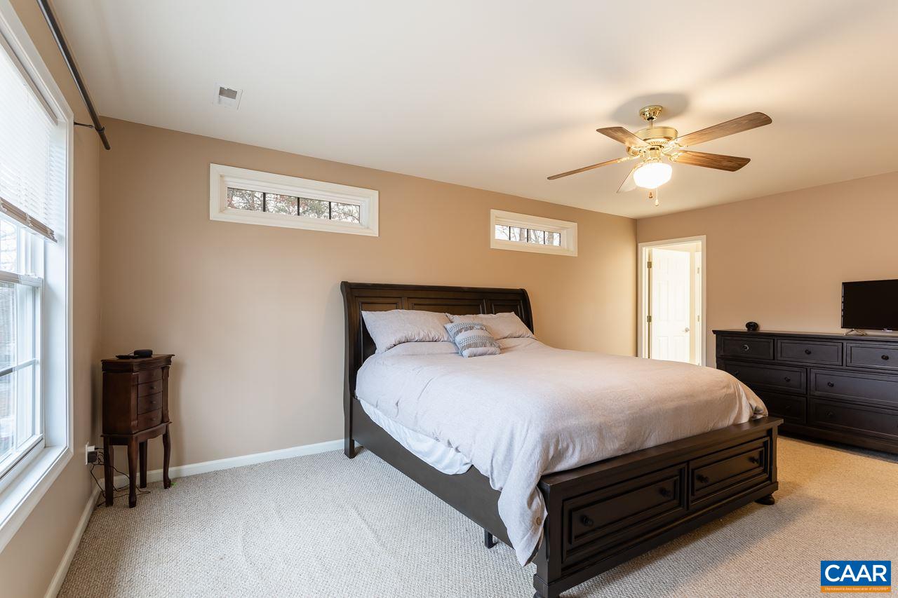 30 Amethyst Road Palmyra, VA 22963 - Photo 18 of 37 a bedroom with a bed and a chandelier