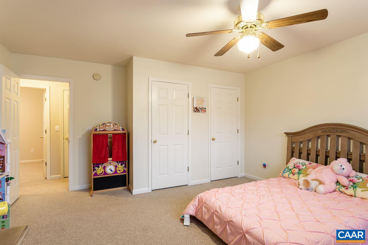 30 Amethyst Road Palmyra, VA 22963 - Photo 25 of 37 a bedroom with a bed and a chandelier