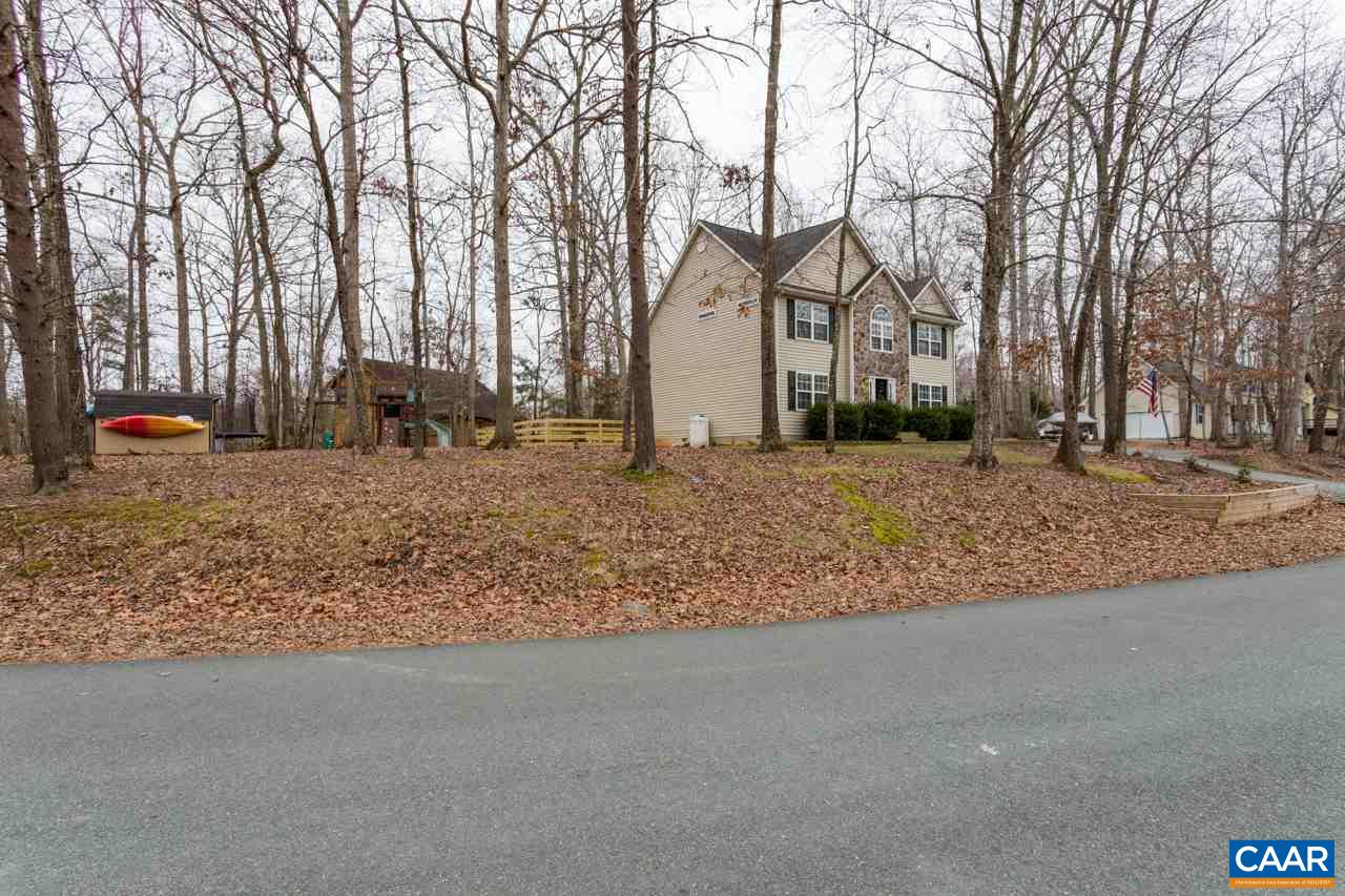 30 Amethyst Road Palmyra, VA 22963 - Photo 34 of 37 a backyard of a house with large trees and covered with wooden fence