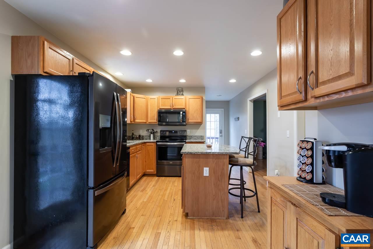 30 Amethyst Road Palmyra, VA 22963 - Photo 9 of 37 a kitchen with stainless steel appliances kitchen island granite countertop a refrigerator a stove top oven a sink and dishwasher
