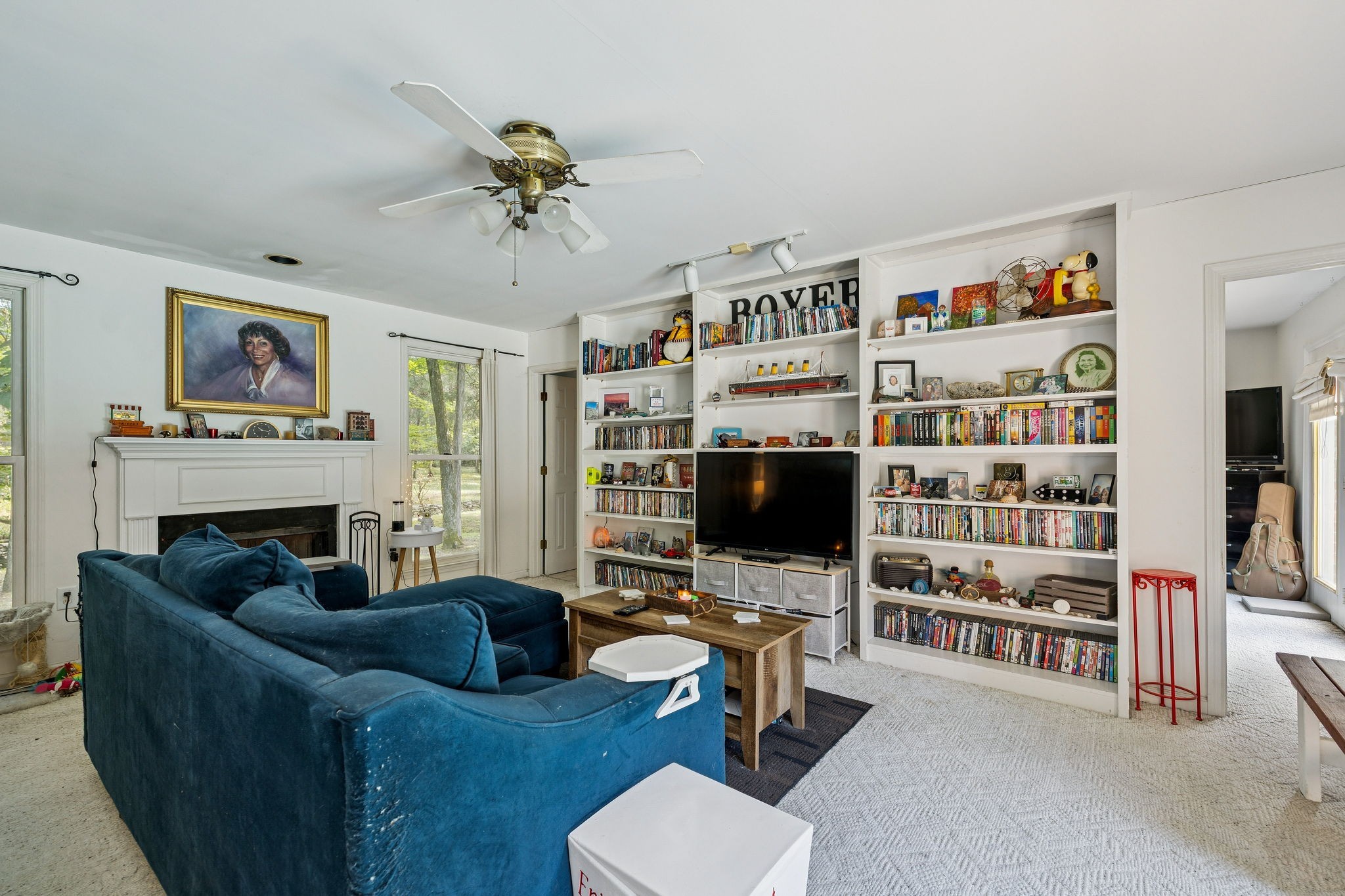 1030 Waller Road Brentwood, TN 37027 - Photo 77 of 90 a living room with furniture a bookshelf and a flat screen tv