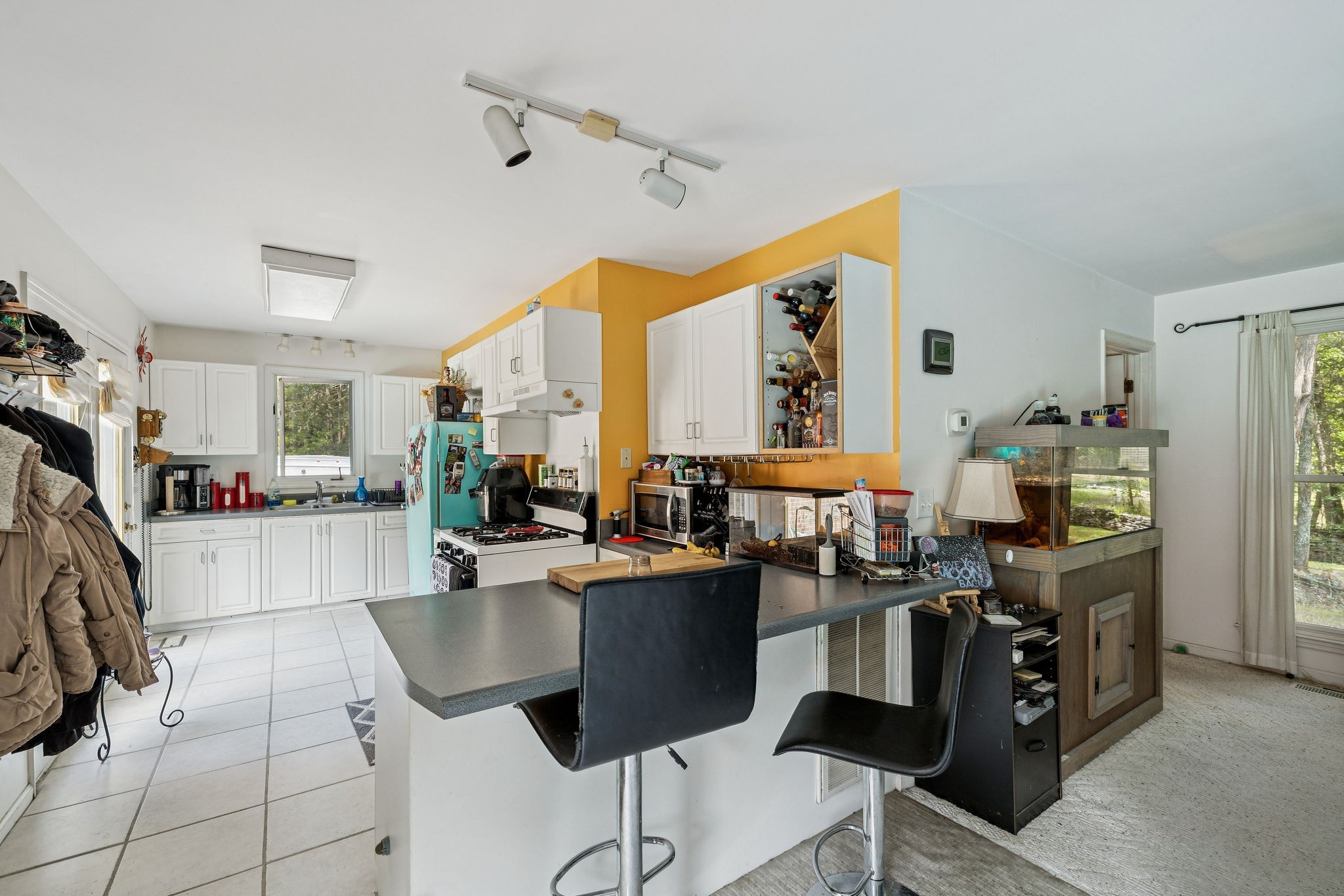 1030 Waller Road Brentwood, TN 37027 - Photo 78 of 90 a room with stainless steel appliances kitchen island granite countertop a table chairs and a refrigerator