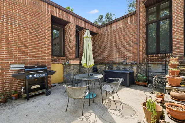 a view of a patio with chairs and a stove