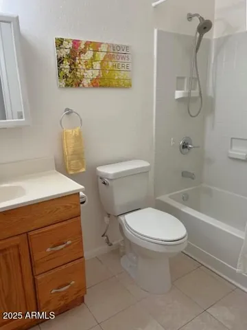a white toilet sitting next to a bath tub