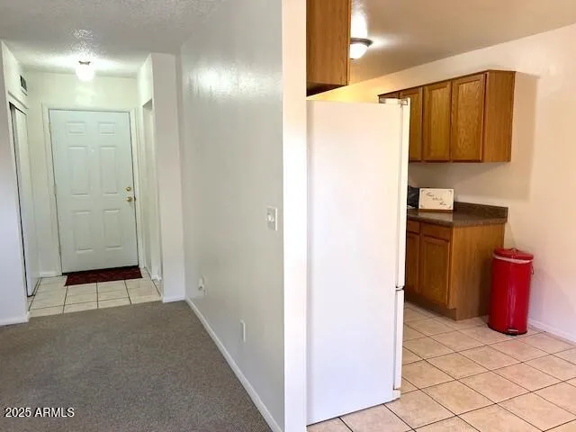 a kitchen with a refrigerator sink and cabinets