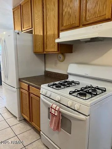a view of empty room with a fireplace and windows