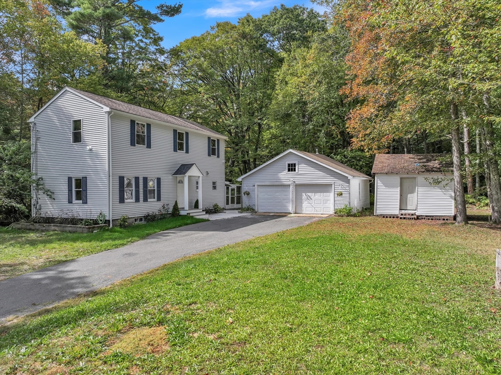54 Mashapaug Road Holland, MA 01521 - Photo 1 of 42 a front view of a house with garden