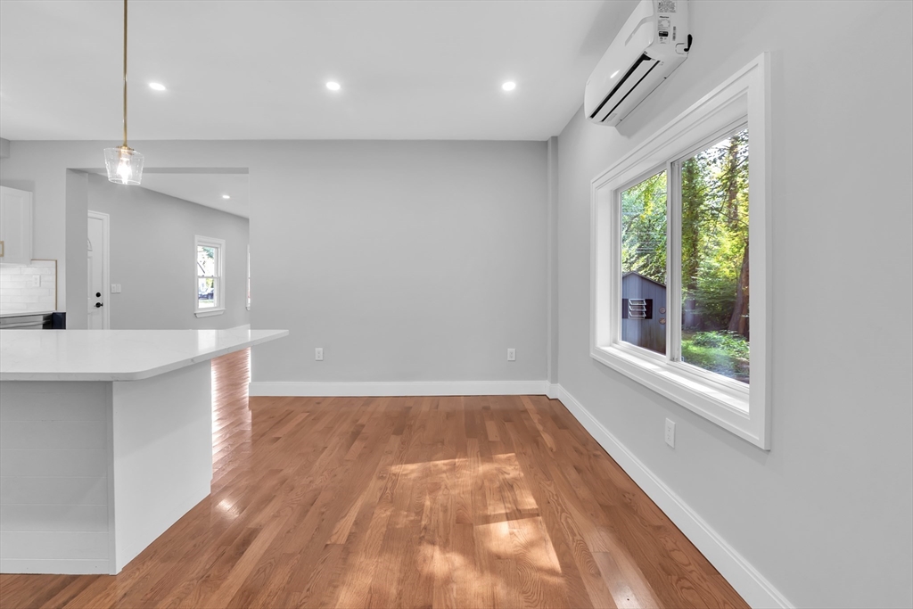 54 Mashapaug Road Holland, MA 01521 - Photo 17 of 42 an empty room with wooden floor and windows