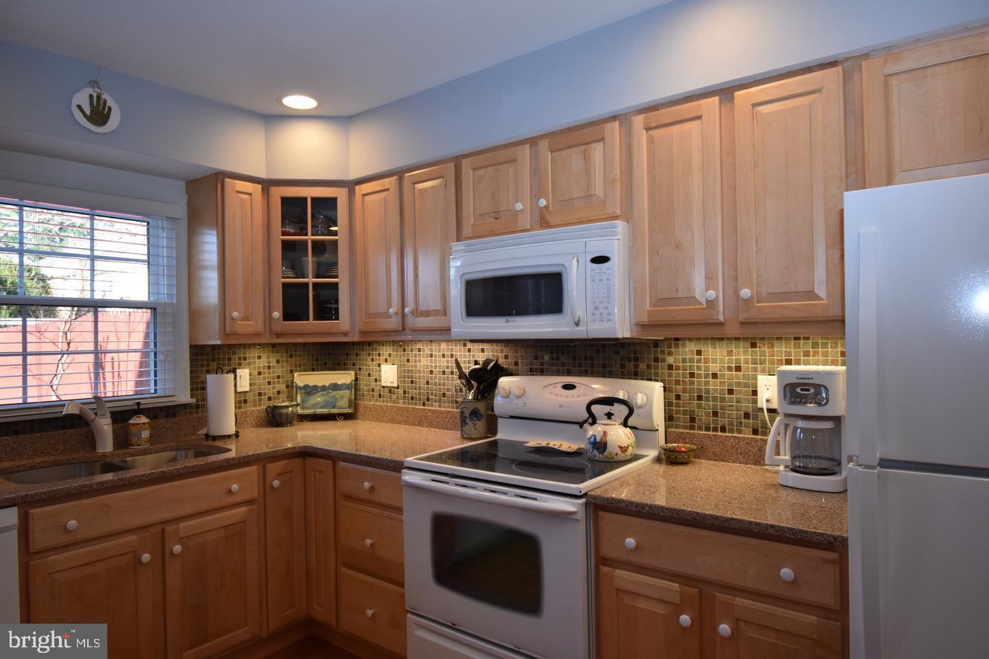 8244 Carrleigh Parkway Springfield, VA 22152 - Photo 11 of 25 a kitchen with stainless steel appliances granite countertop a sink stove and microwave