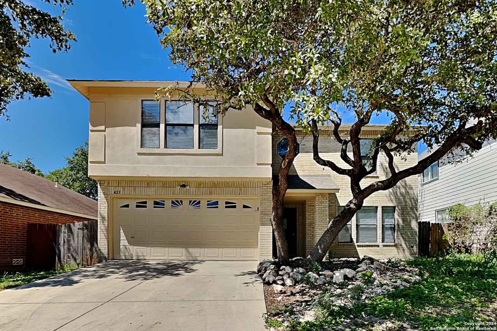front view of a house with a tree