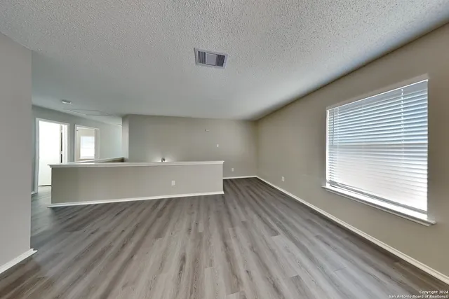 a view of room with window and wooden floor