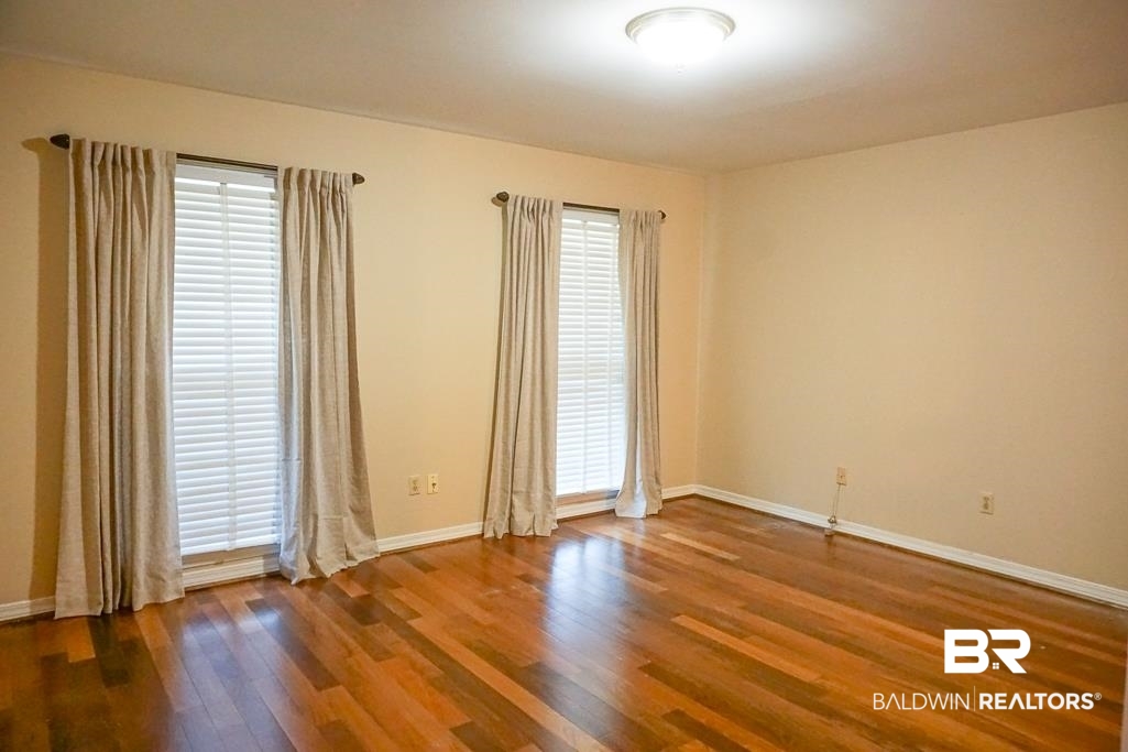 255 Suffolk Road Mobile, AL 36608 - Photo 15 of 29 Empty room featuring dark wood-style floors