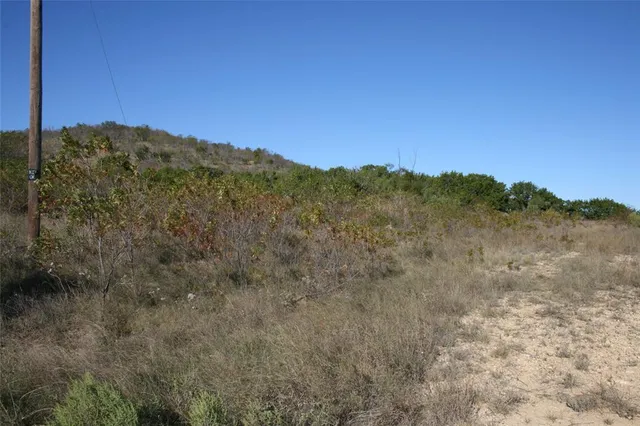 a view of mountain with sunset in background