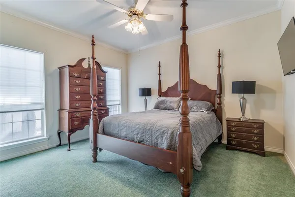 a spacious bedroom with a bed chandelier and a window