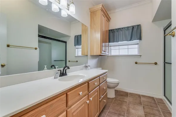 a bathroom with a sink a toilet and mirror