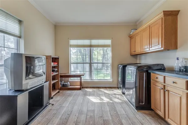a kitchen with stainless steel appliances wooden floors and wooden cabinets