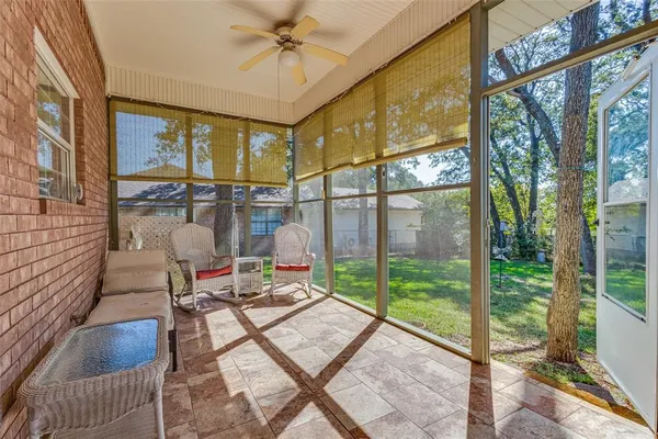 a living room with a floor to ceiling window and floor to ceiling window