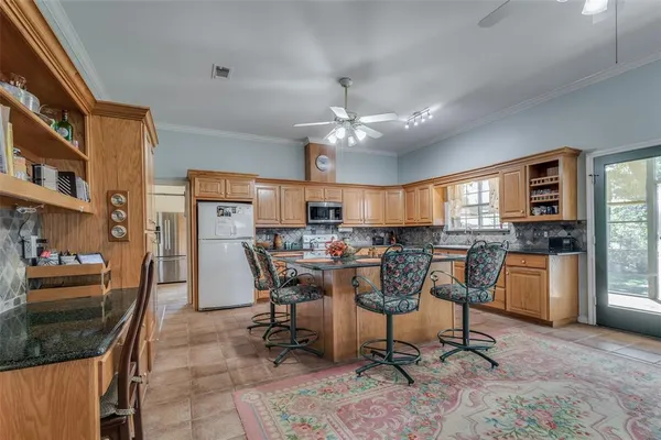 a view of a dining room with furniture and a kitchen