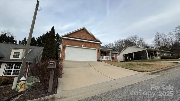 a front view of a house with parking space