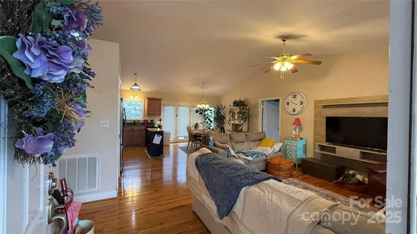a living room with furniture a flat screen tv and a potted plant