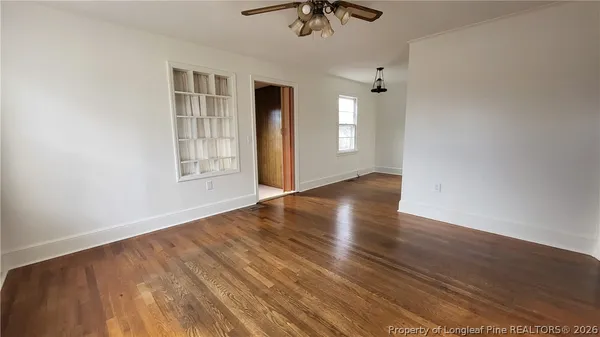 wooden floor in an empty room with a window