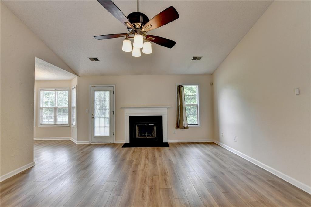 601 Bowling Lane Winder, GA 30680 - Photo 11 of 45 a view of an empty room with a window and wooden floor