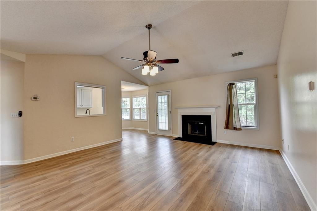 601 Bowling Lane Winder, GA 30680 - Photo 12 of 45 a view of a livingroom with wooden floor fireplace and windows