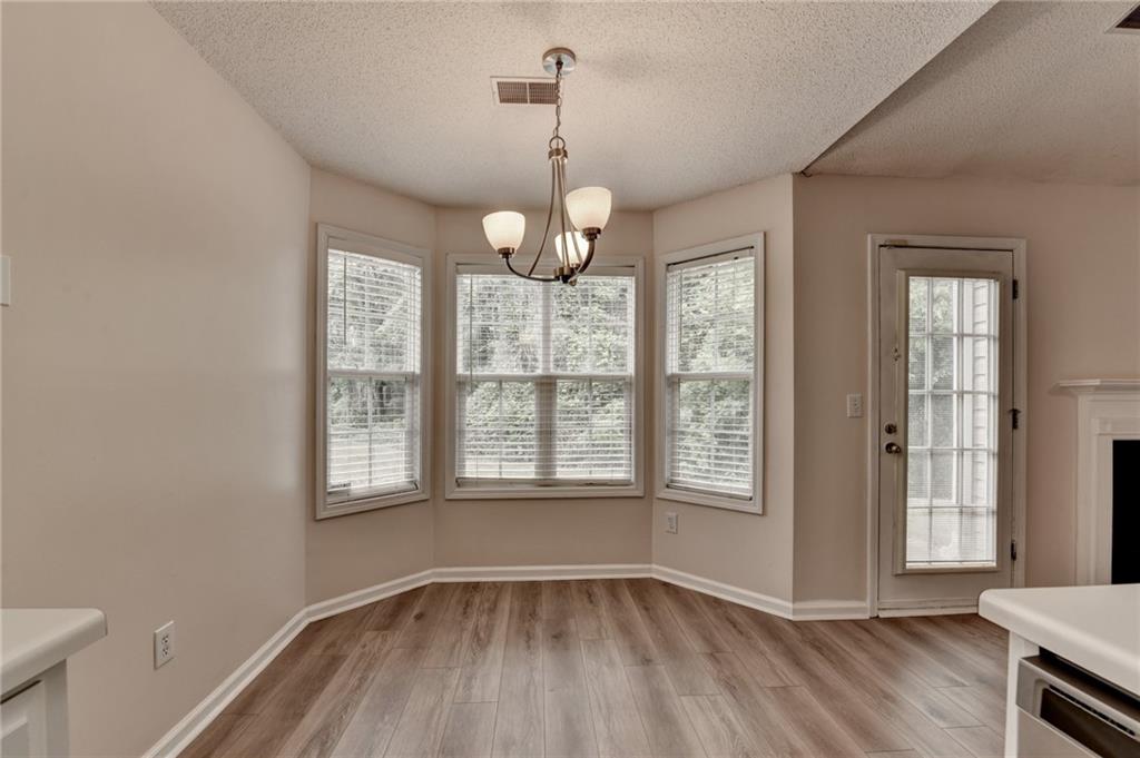 601 Bowling Lane Winder, GA 30680 - Photo 17 of 45 a view of an empty room with wooden floor and a window