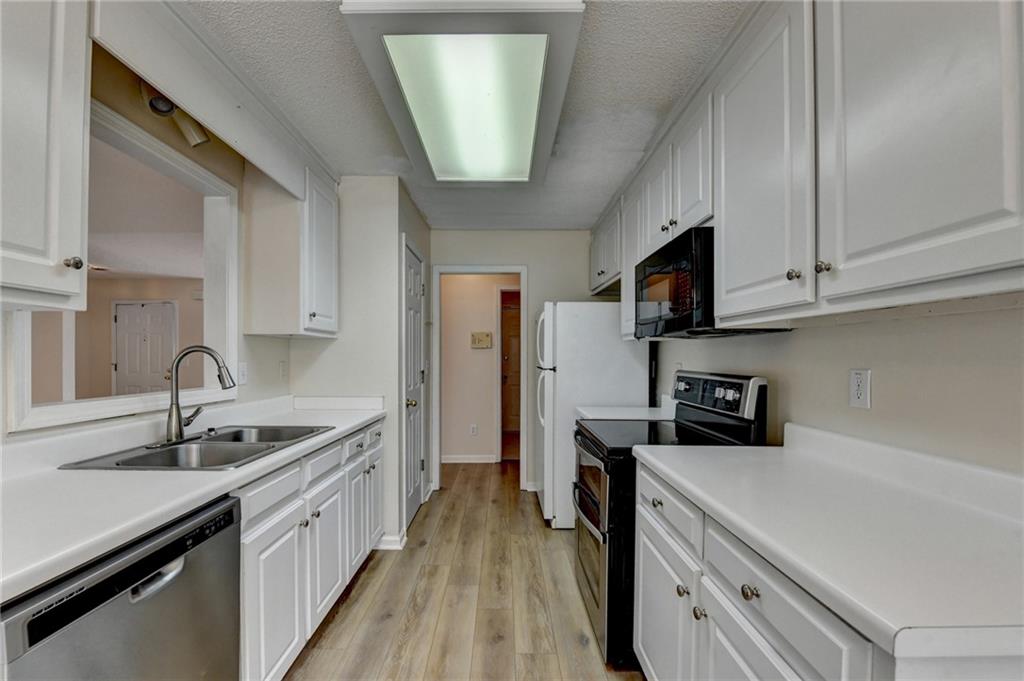 601 Bowling Lane Winder, GA 30680 - Photo 19 of 45 a kitchen with stainless steel appliances granite countertop a sink a stove and a refrigerator
