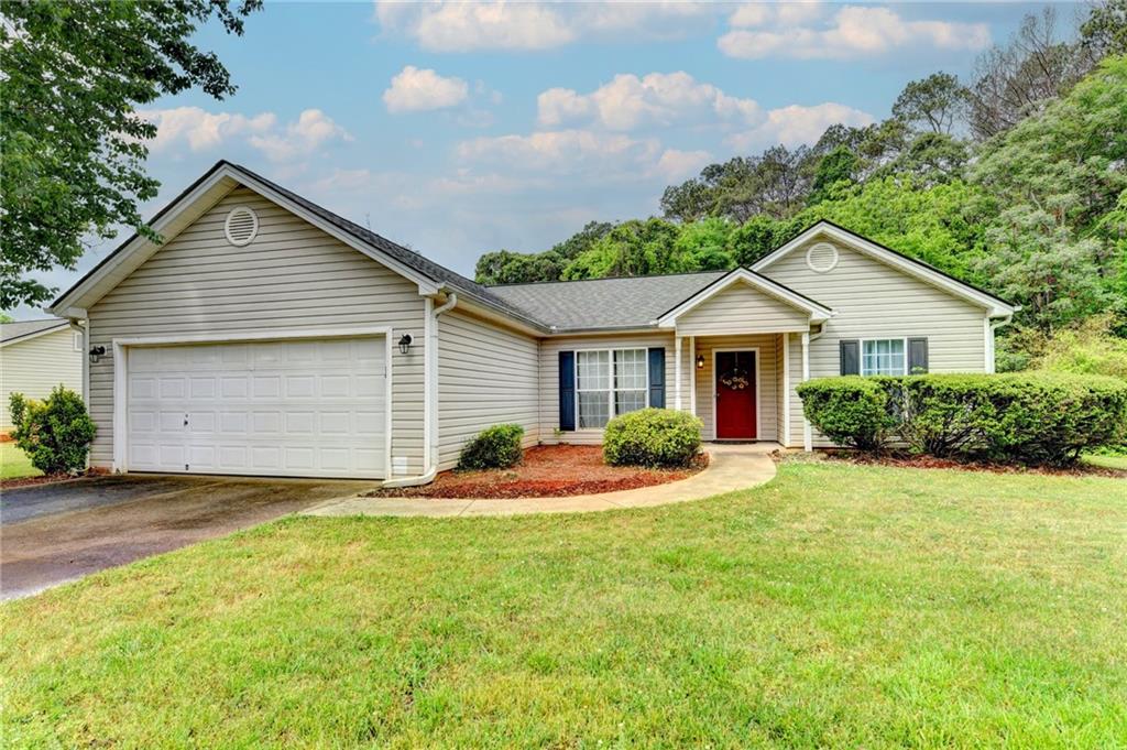601 Bowling Lane Winder, GA 30680 - Photo 2 of 45 a front view of house with yard and trees in the background