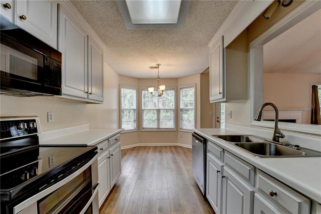 601 Bowling Lane Winder, GA 30680 - Photo 23 of 45 a kitchen with stainless steel appliances a sink a stove and cabinets