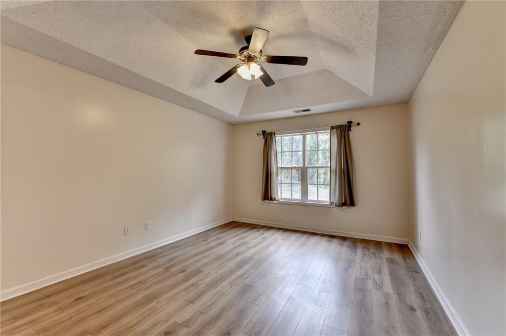 601 Bowling Lane Winder, GA 30680 - Photo 25 of 45 a view of wooden floor and a chandelier fan in a room
