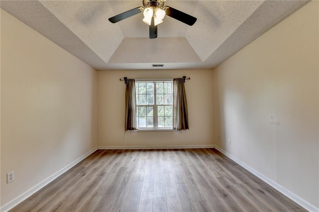 601 Bowling Lane Winder, GA 30680 - Photo 26 of 45 wooden floor in an empty room with a window