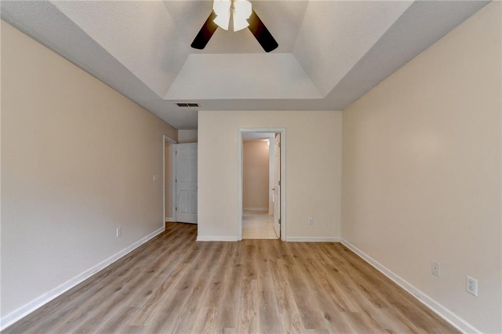 601 Bowling Lane Winder, GA 30680 - Photo 28 of 45 an empty room with wooden floor cabinet and windows