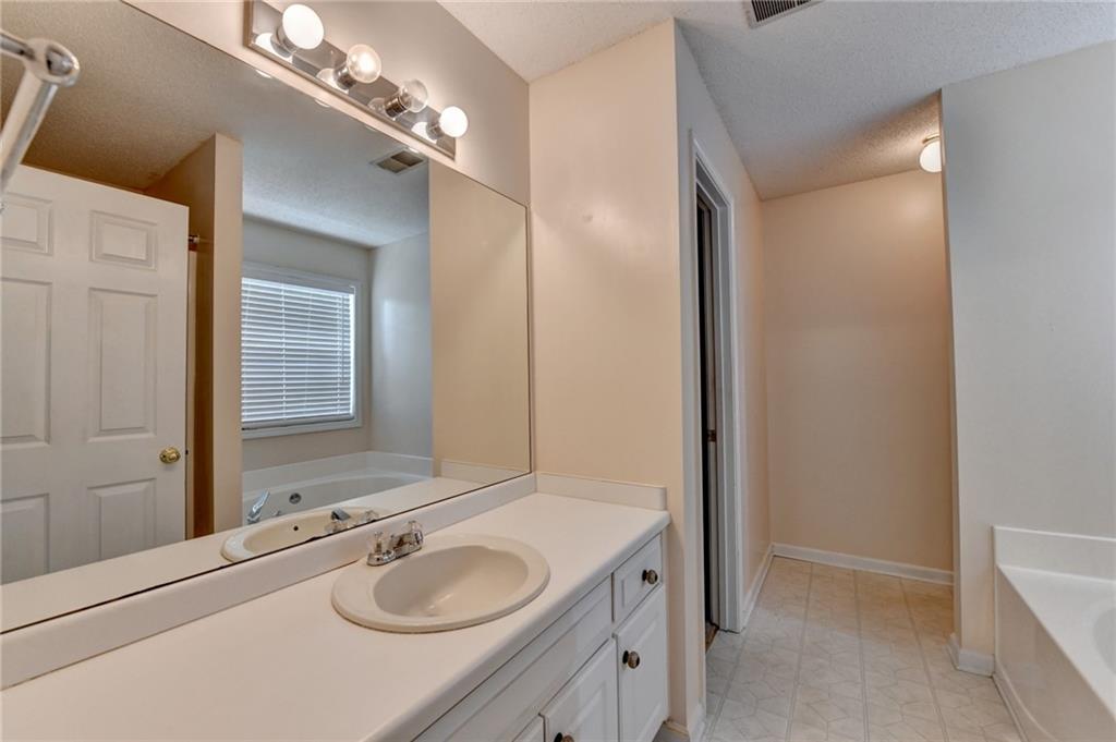 601 Bowling Lane Winder, GA 30680 - Photo 29 of 45 a bathroom with a granite countertop sink and a mirror