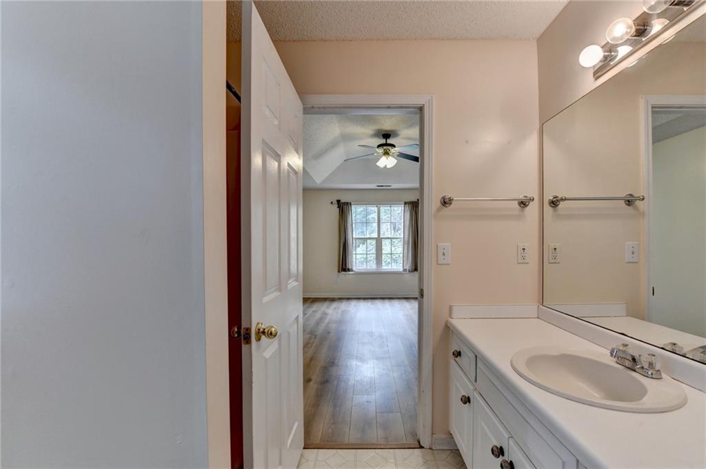 601 Bowling Lane Winder, GA 30680 - Photo 31 of 45 a bathroom with a granite countertop sink a mirror and a shower