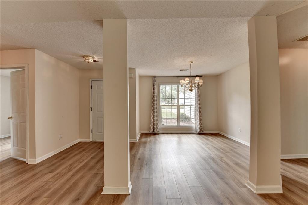 601 Bowling Lane Winder, GA 30680 - Photo 34 of 45 an empty room with wooden floor and windows