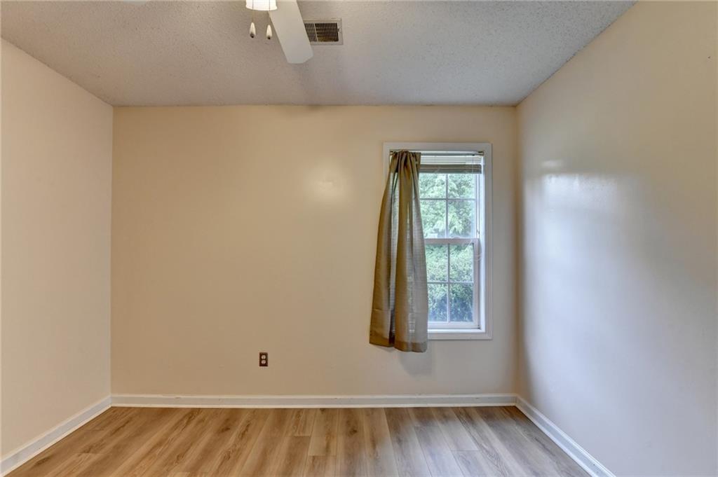 601 Bowling Lane Winder, GA 30680 - Photo 39 of 45 an empty room with wooden floor and windows
