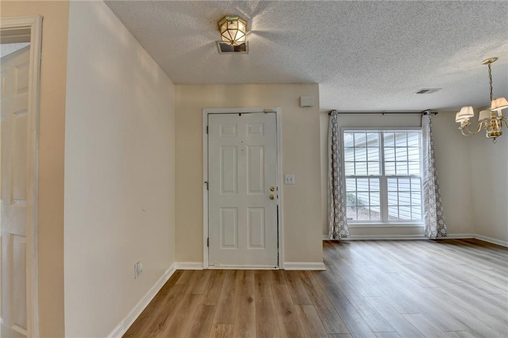 601 Bowling Lane Winder, GA 30680 - Photo 4 of 45 an empty room with wooden floor and windows